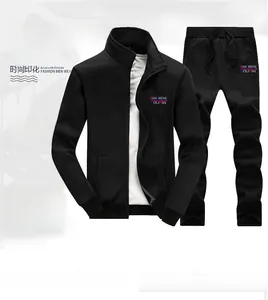 Detail of black men's tracksuit jacket featuring a stand collar and red-blue logo print