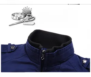 Detail of navy cotton canvas jacket showing black ribbed stand collar and metal zipper