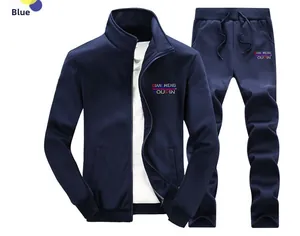 Detail view of navy blue track jacket and joggers set with red accent logo and pockets