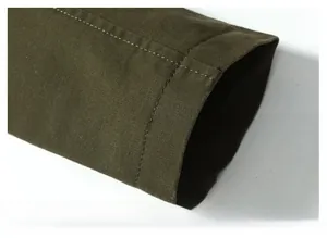 Close-up of windproof cuffs with double stitching on dark green twill cotton jacket