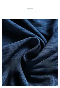 Macro shot of dark blue ice silk fabric showing fine horizontal texture and elasticity