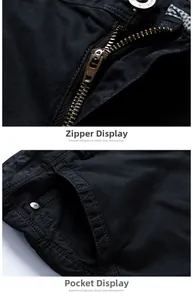 Detail of black cotton cargo shorts showing metal zipper and fashion button texture