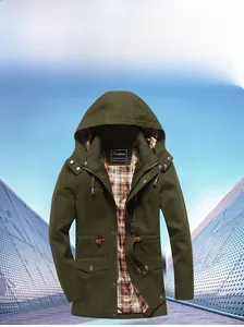 Detailed view of olive green parka with zipper, flap pockets and classic plaid lining