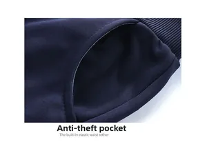 Detail of dark blue sports pants showing anti-theft pocket and internal drawstring