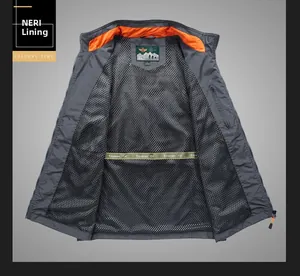 Detail view of breathable mesh lining and orange contrast collar on dark gray fishing vest