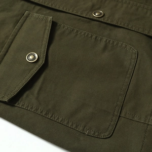 Army green military style cotton jacket detail with metal buttons and flap pockets