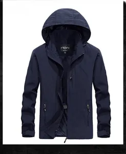 Detail view of water-resistant navy blue men's jacket with hood and functional pockets
