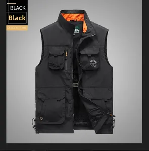 Detail of black tactical vest showing functional multi-pockets and zip closure with orange lining