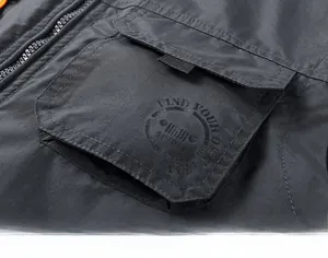Detail of cargo pocket on dark grey functional vest with FIND YOUR OWN WAY graphic print