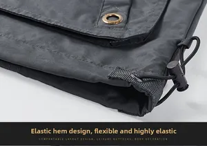 Detailed macro view of the adjustable elastic drawstring hem on the dark gray jacket