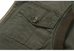 Detailed view of army green canvas vest featuring metal buttons and utility pockets