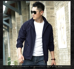 Close-up of lightweight navy blue hooded windbreaker jacket with waterproof texture