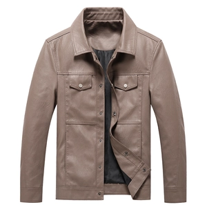 Detail of mocha brown leather jacket with flap chest pockets and metallic buttons