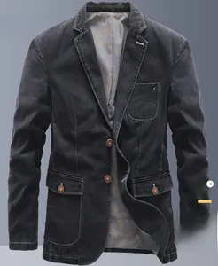 Detailed view of dark wash denim blazer jacket featuring classic notched lapels and flap pockets