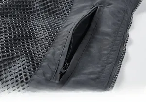 Detailed macro view of dark grey tactical vest with anti-theft inner zipper pocket