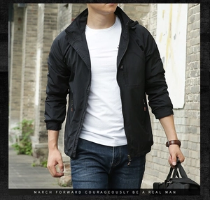 Detail of a men's lightweight black hooded jacket with windproof fabric and zip pockets