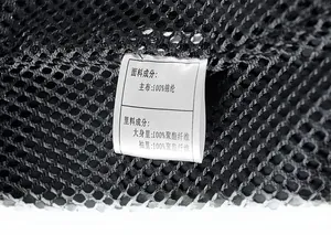 Detail shot of care label on black mesh lining showing nylon and polyester fabric content