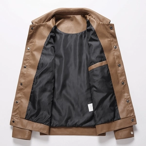 Detail of brown leather jacket lapel with vintage metal buttons and black inner pocket