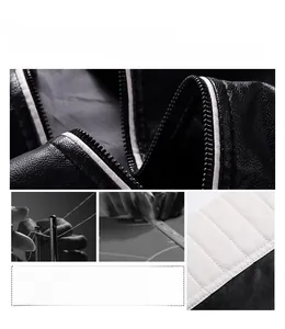Détail de la veste de motard en similicuir avec coutures noir et blanc et texture matelassée