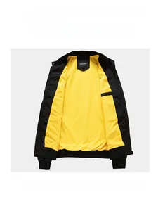 Detail of black windbreaker jacket with striking yellow lining and ribbed cuffs