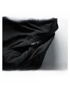 Detail shot of the detachable hooded zipper design on a black men's jacket
