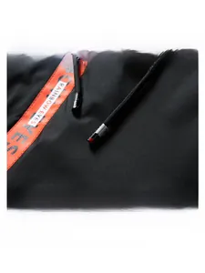 Detail of hood drawstring with metal tips and orange rainbow eyes text ribbon