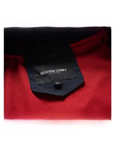 Detail of red honeycomb mesh lining and brand label on a casual men's jacket
