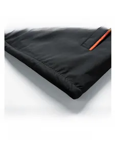 Detail of jacket hem showing dense weave fabric and orange contrast edge stitching