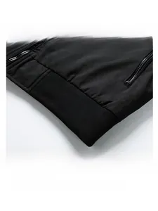 Detail view of black bomber jacket with ribbed hem and metallic side zipper pocket