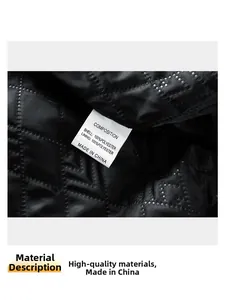 Detail of black quilted fabric with white 100% polyester fiber composition tag