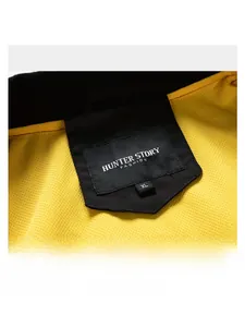 Detail of jacket neckline with yellow mesh lining, brand woven label, and size XL tag