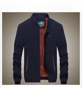 Detail of navy stand-collar jacket featuring warm brown fleece lining and ribbed cuffs