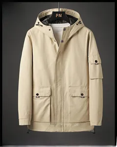 Detail of light khaki hooded cotton jacket featuring utility pockets and zip closure