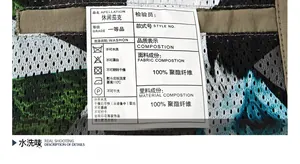 Close-up of garment care label showing 100% polyester fabric and washing instructions