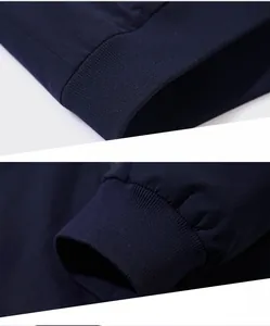 Detailed close-up of ribbed knit cuffs and hem on a navy blue casual jacket