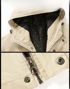 Detail of beige cotton utility jacket showing hood drawstrings and metal zipper