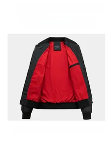 Detail view of bomber jacket showing black outer shell and bright red contrast lining