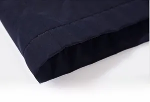 Detailed close-up of a sturdy men's fleece-lined jacket hem with tight double stitching