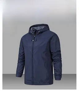 Detail of denim blue hooded windbreaker showing ripstop texture and elastic cuffs