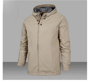 Detail of khaki outdoor jacket featuring adjustable drawstring hood and velcro cuffs