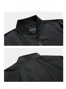 Detailed view of black slim-fit bomber jacket collar with embroidery and premium metal zipper