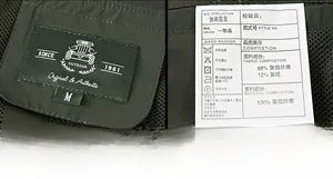 Detail view of the collar label and washing instructions on a green outdoor jacket