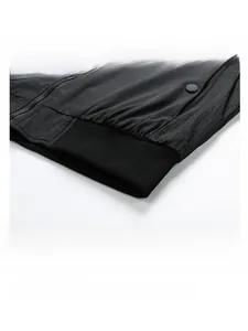 Macro detail of men's slim fit jacket showing metal zipper and ribbed hem with punch holes