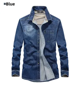 Detail of blue long-sleeve denim shirt showing standard collar and front pocket