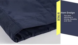 Detailed close-up of heavy-duty double-stitched hem on a navy outdoor jacket