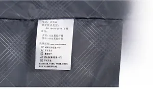 Detailed close-up of inner washing label and grey diamond quilted lining of the jacket
