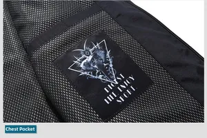 Detail of chest pocket on black camouflage jacket with mesh lining and brand patch