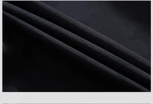 Close-up of durable black fabric texture showing fine mesh weave and neat stitching detail