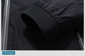 Close-up of black camouflage jacket showing ribbed knit cuffs and windproof fabric texture