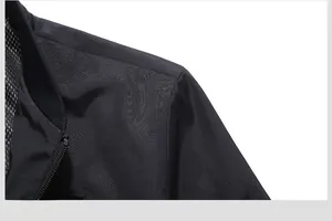 Detailed macro view of black bomber jacket shoulder with mesh lining and ribbed collar